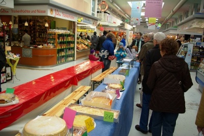 Besucher an der Tischreihe der Käsekuchen